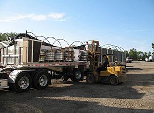 A large truck with a forklift on the back of it.